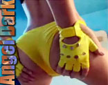 Angel Dark con zapatos amarillos extravagantes y guantes se lo monta con dos hombres